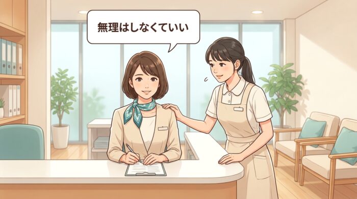 受付カウンターで落ち着いて応対する受付スタッフと寄り添う同僚